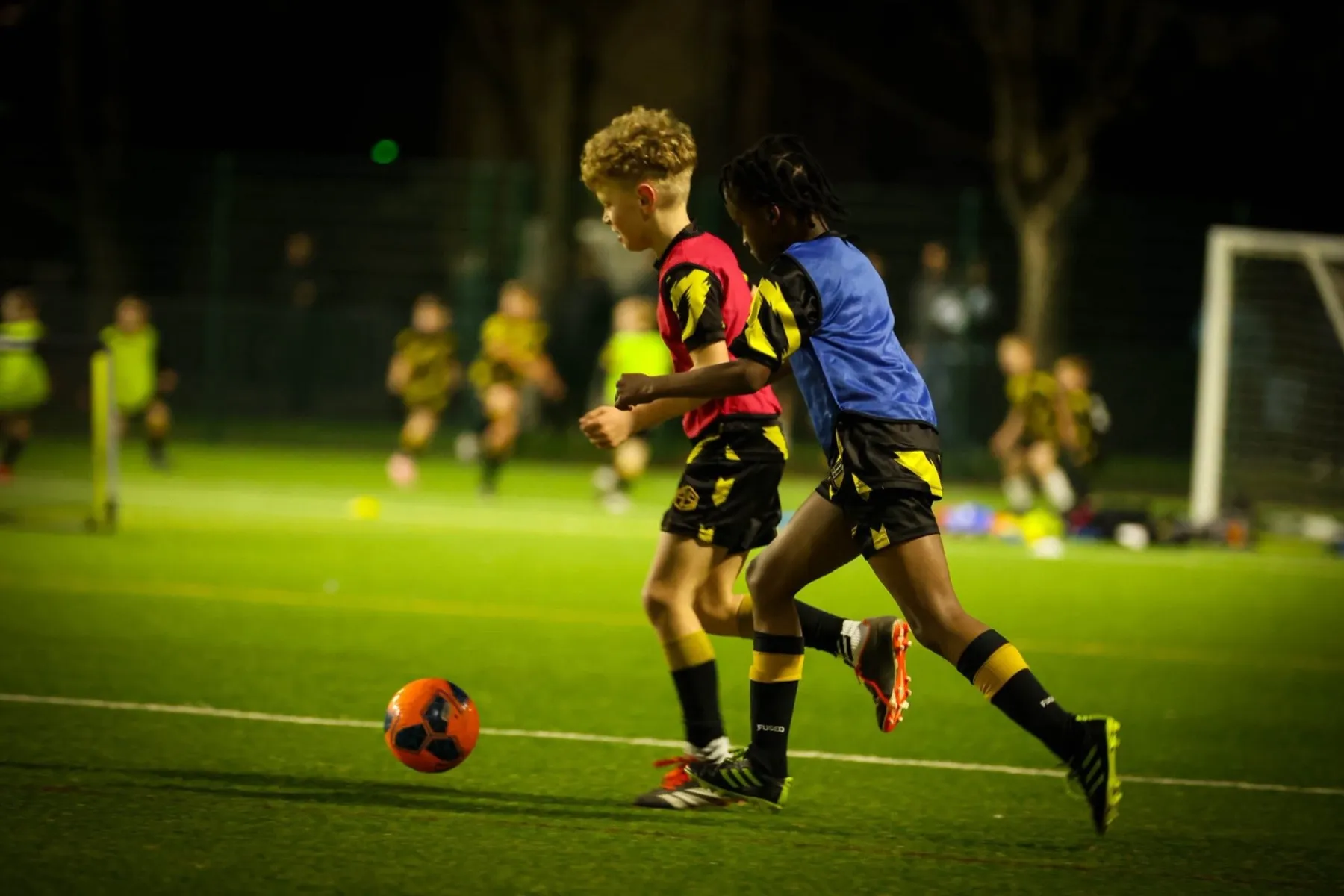 Two young players competing for the ball during a match