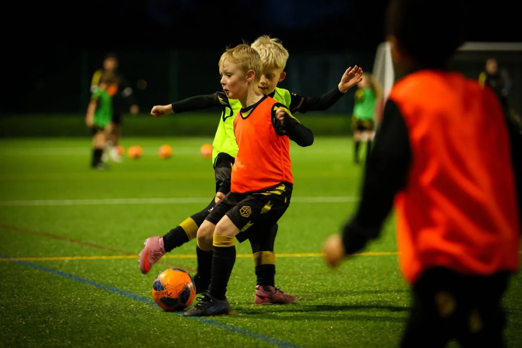 Young players competing for the ball during a session